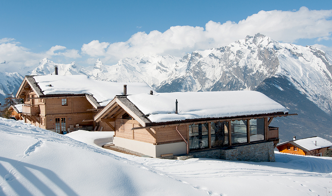 swiss chalet covered in snow