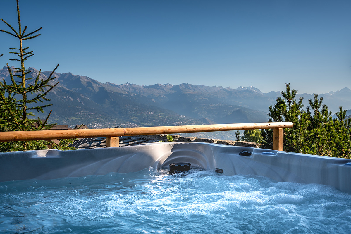 bubble bath jacuzzi views over the Valais mountains in a rental chalet