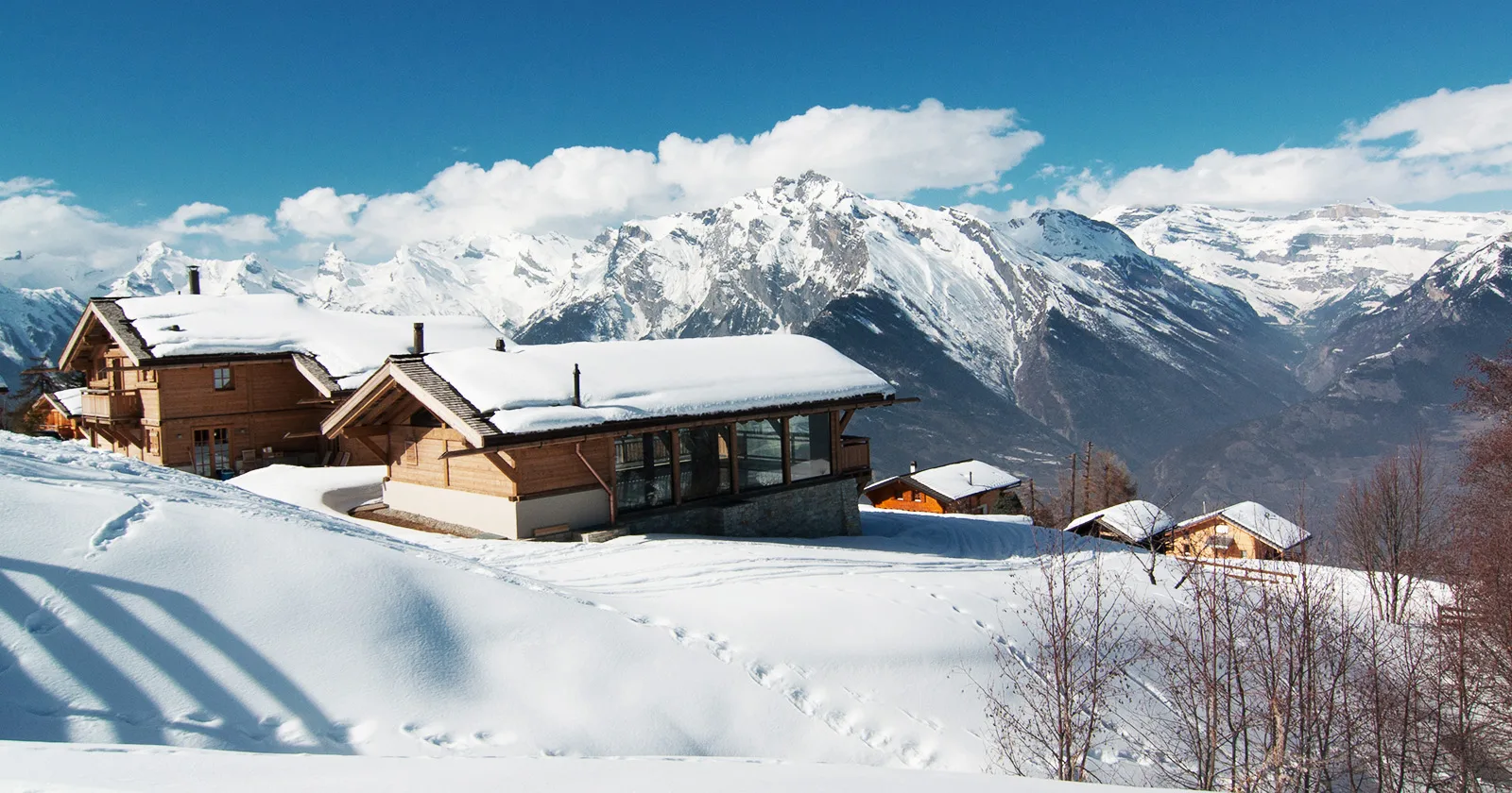 Luxury Swiss Chalet covered in Snow facing at the mountains in Switzerland
